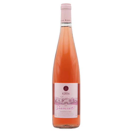 Château Ksara Sunset Rosé wine bottle from BERKMANN CELLARS with a sunset-themed label, displayed on a wooden surface.